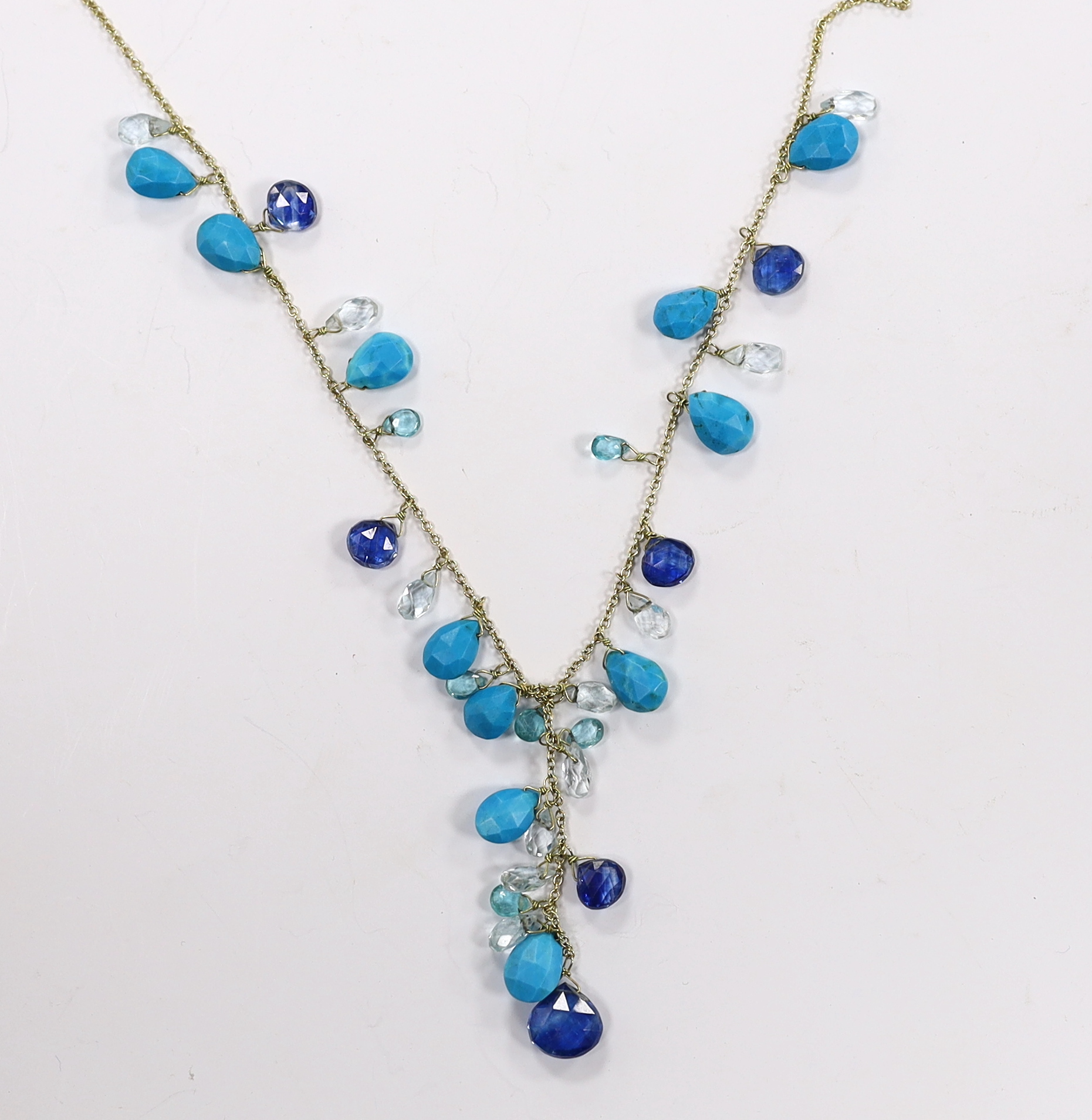 A modern 18ct gold and multi facet cut gem set fringe necklace, 56cm and matching bracelet, gross weight 21 grams